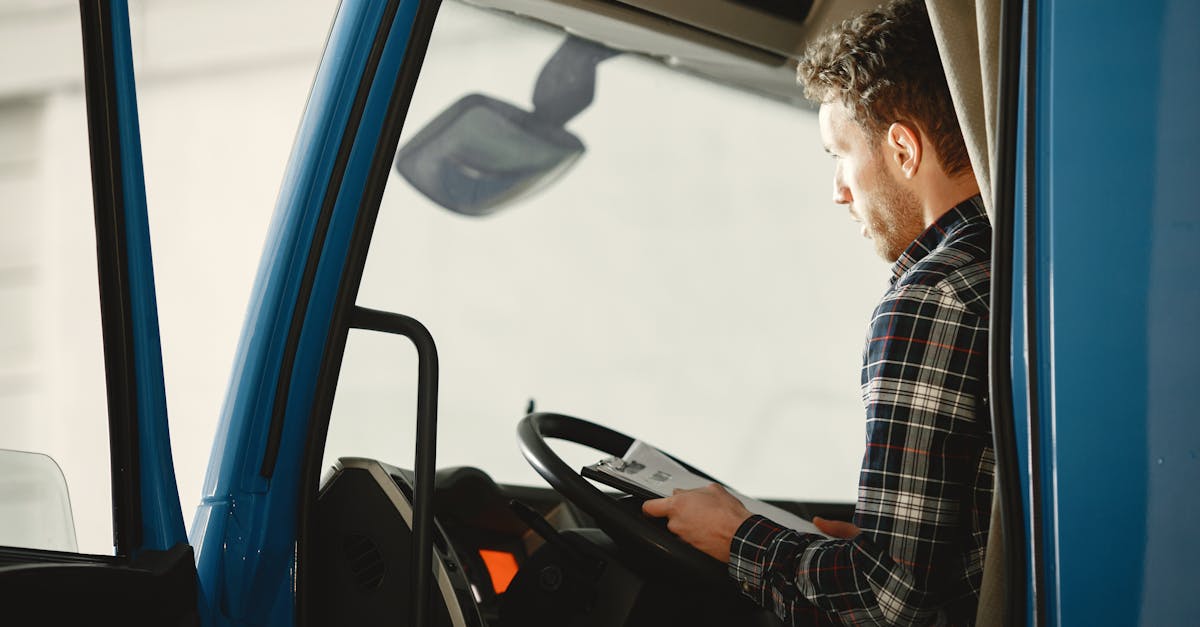 Truck driver reviewing records and documents inside the cab